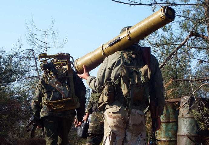 A rebel fighter carries an anti-tank weapon as he heads with his fellow fighters towards their positions in the Armenian Christian town of Kasab April 23, 2014. (Reuters/Alaa Khweled)