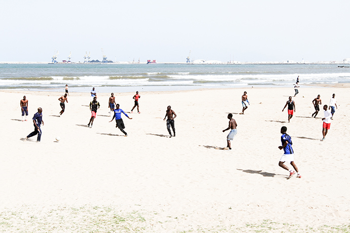 A group of migrants, who managed to scale Melillaâs wall, play football on a beach of the Spanish enclave. Photo by @TomasoClavarino