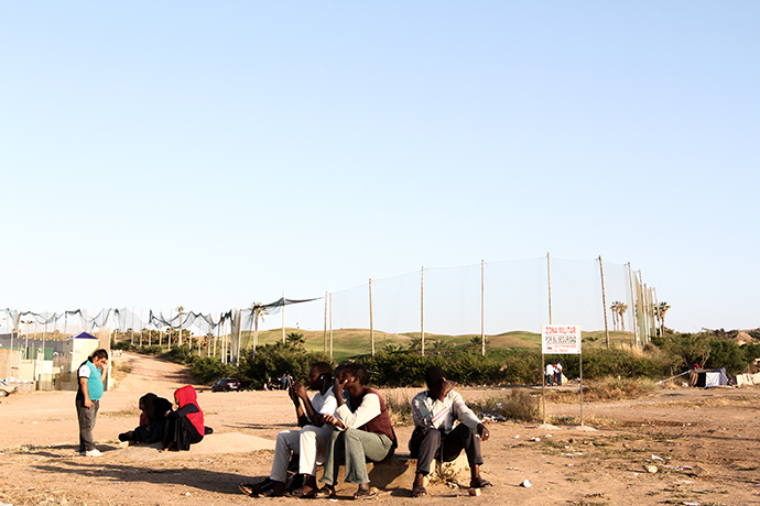 Malian migrants waiting for dinner in front of Melillaâs CETI (Centro de Estancia Temporal de Inmigrantes). Photo by @TomasoClavarino