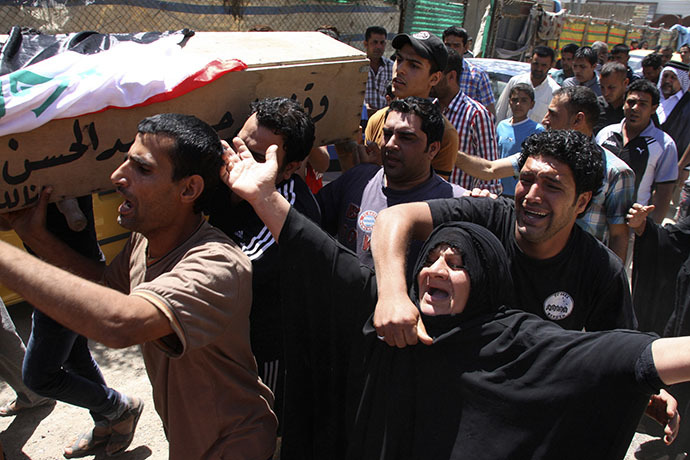 People attend the funeral of an Iraqi soldier in Baghdad April 25, 2013. The soldier was killed on the second day of clashes following the storming of a Sunni Muslim protest camp by Iraqi forces, in Hawija, near Kirkuk, 170 km (100 miles) north of Baghdad. (Reuters / Wissm al-Okili)
