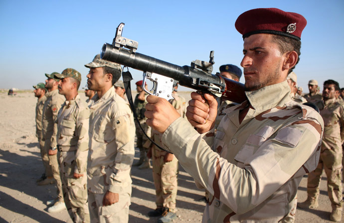 Members of a newly formed brigade of Iraqi Shiite fighters parade in military fatigues with their weapons on June 24, 2014 in the southern city of Basra as thousands of Shiite volunteers join Iraqi security forces in the fight against Sunni Jihadist militants who have taken over several northern Iraqi cities. (AFP Photo / Haidar Mohammed Ali)