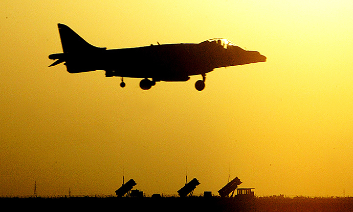 A Royal Air Force Harrier GR7 from 4 Squadron comes into land over a battery of patriot missile in Kuwait after patrollng the no fly zone in southern Iraqs March 14, 2003 (Reuters)