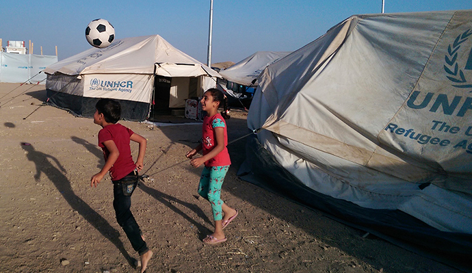 Children, who fled from violence in Mosul, play with a ball inside the Khazer refugee camp on the outskirts of Arbil, in Iraq's Kurdistan region, June 30, 2014 (Reuters / Murad Talaat)
