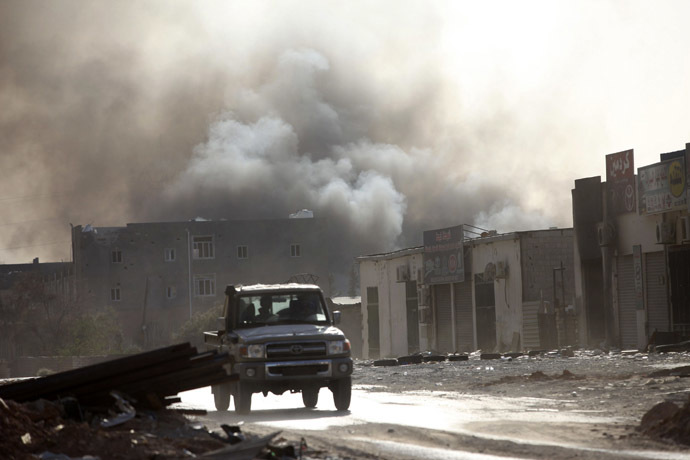 Smoke rises after rockets fired by one of Libya's militias struck and ignited a building after clashes between rival militias, in an area at Alswani road in Tripoli August 2, 2014. (Reuters/Hani Amara)