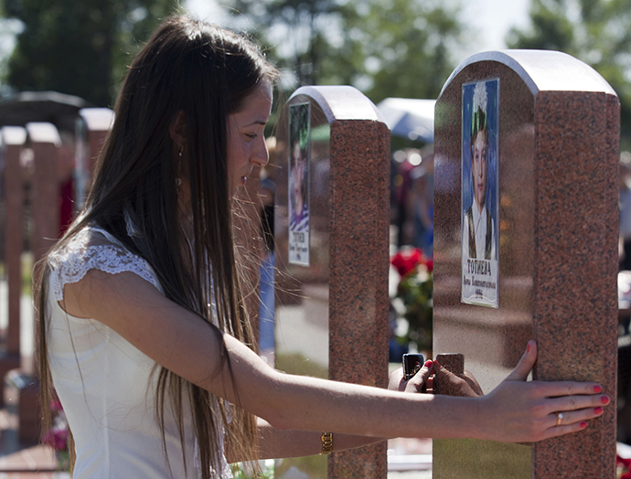 A young woman during a service in the memorial cemetery in Beslan, where those killed in the terrorist attack in school â 1 on September 1, 2004 are buried (Reuters / Anton Podgaiko)