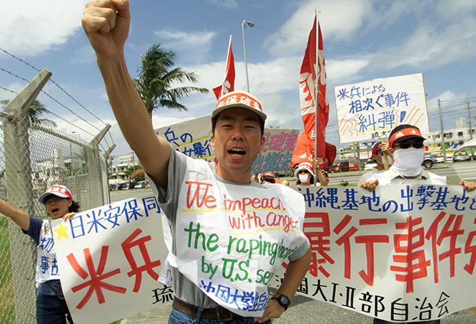 An Okinawan student raises his fists and shouts anti-U.S. slogans with his colleagues to protest the rape of a young Japanese woman and the U.S. miltary presence in Japan. (Reuters)