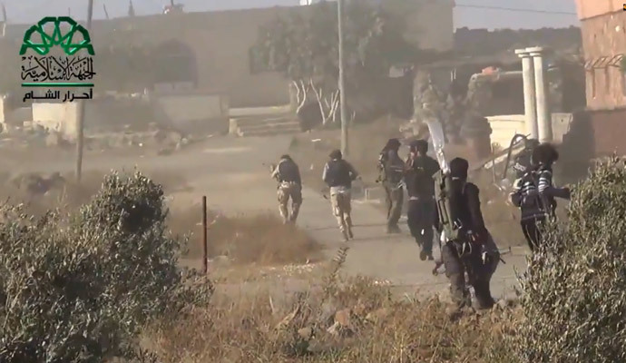 Opposition fighters advancing as they capture a Syrian government forces position in the village of Khan Arnabeh, near the eastern border crossing of Quneitra with Israel in the Golan Heights. (AFP Photo / HO / Ahrar Al-Sham)