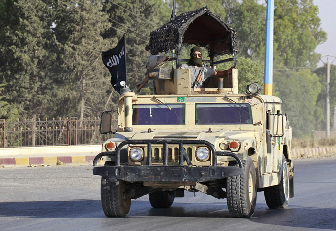 Militant Islamist fighters take part in a military parade along the streets of Syria's northern Raqqa province June 30, 2014. (Reuters/Stringer)