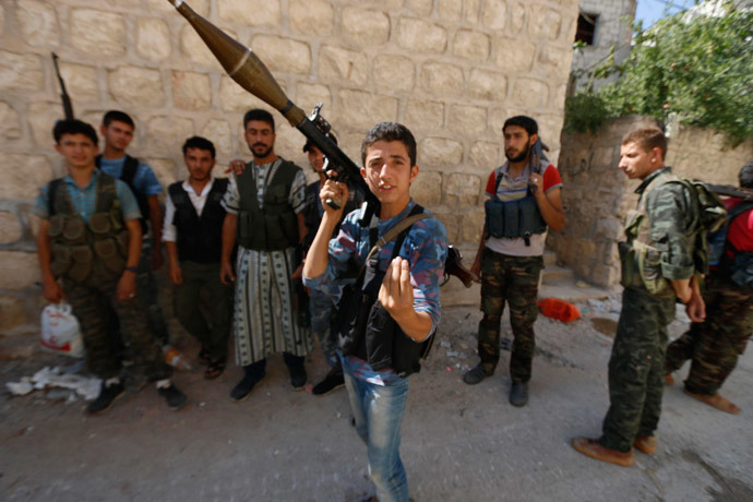 A Free Syrian Army fighter reacts to the camera at the Handarat camp frontline, an area located beside Aleppo Central prison July 7, 2014. (Reuters / Hosam Katan)