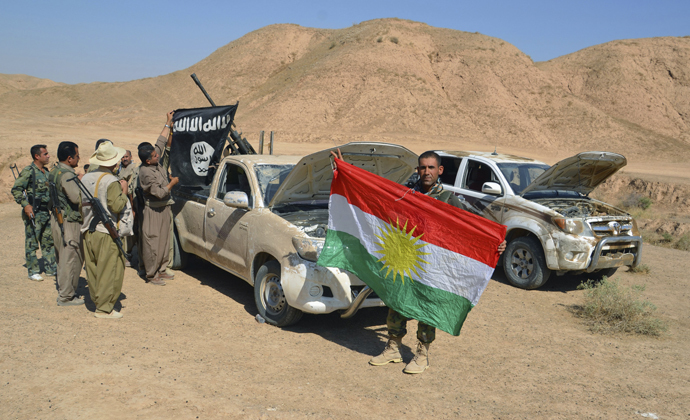 Kurdish peshmerga fighters examine vehicles with weapons and ammunition left behind by fleeing Islamic State militants during clashes in the al-Zerga area near Tikrit city in Salahuddin province October 8, 2014. (Reuters/Stringer)