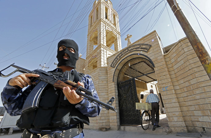 An Iraqi security officer, stands guard outside the Church of the Virgin Mary in the northern town of Bartala, on June 15, 2012, east of the northern city of Mosul. (AFP Photo/Karim Sahib)