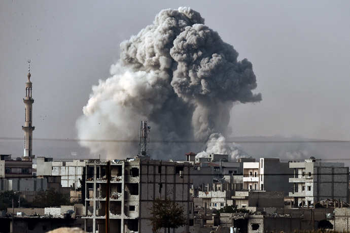 Smoke rises from the the Syrian town of Ain al-Arab, known as Kobane by the Kurds, after a strike from the US-led coalition as it seen from the Turkish-Syrian border in the southeastern village of Mursitpinar, Sanliurfa province, on October 14, 2014. (AFP Photo/Aris Messinis)