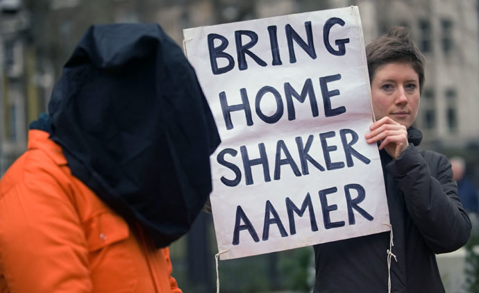 A protestor holds up a sign calling for the release of Shaker Aamer from the Guantanamo prison during a demonstration in central London, on January 11, 2010. (AFP Photo/Leon Neal)