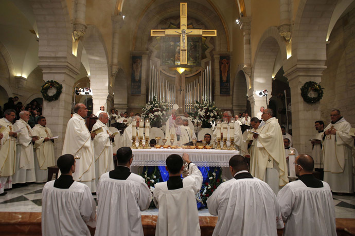 Christian priests hold a Christmas Midnight Mass at the Church of the Nativity in the West Bank town of Bethlehem December 25, 2014. (Reuters/Ammar Awad)