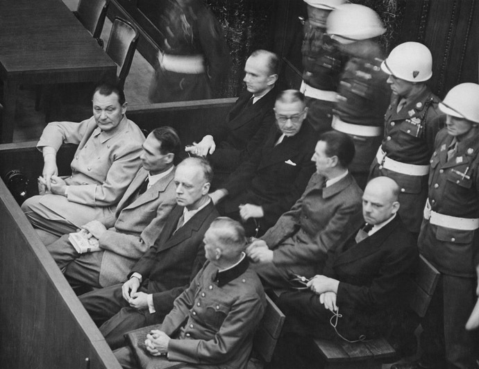 Nuremberg Trials. Defendants in their dock, circa 1945-1946. (in front row, from left to right): Hermann Göring, Rudolf HeÃ, Joachim von Ribbentrop, Wilhelm Keitel (in second row, from left to right): Karl Dönitz, Erich Raeder, Baldur von Schirach, Fritz Sauckel (Image from Wikipedia)