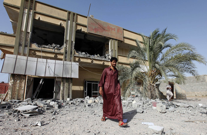 A man walks past the premises of a transport company which the Libyan government said was destroyed by NATO air strikes in Zliten, about 150km (93.2 miles) east of Tripoli July 21, 2011. (Reuters/Ismail Zitouny)