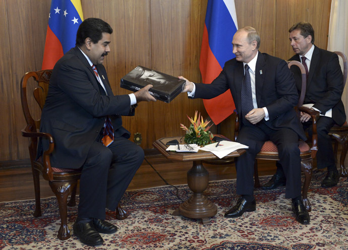 Russia's President Vladimir Putin (2nd R) presents his Venezuelan counterpart Nicolas Maduro with a book dedicated to late Venezuelan President Hugo Chavez during a meeting in Brasilia July 16, 2014. (Reuters/Alexei Nikolskyi/RIA Novosti/Kremlin)
