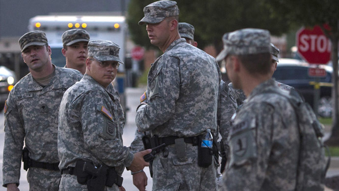 National Guard troops stand at a staging area located at a shopping center parking lot in Ferguson, Missouri (Reuters/Adrees Latif)