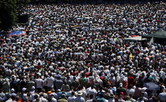 People attend a reburial ceremony of 136 newly identified victims in Potocari, near Srebrenica, Bosnia and Herzegovina July 11, 2015. (Reuters/Stoyan Nenov)